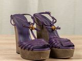 an image of a pair of purple shoes on a wooden table