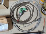 a picture of a hose, a drill, and other tools on a table