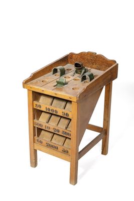 a small wooden table with a bunch of shoes on it
