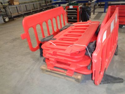 a red bench sitting on a pallet in a warehouse