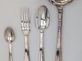 a spoon, fork, spoon and spoon rest on a table