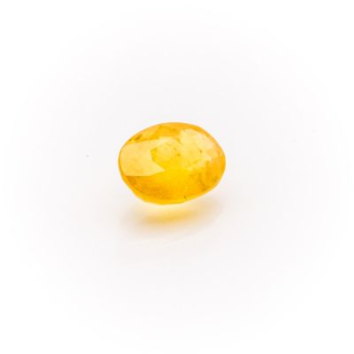 a yellow sapphire stone on a white background