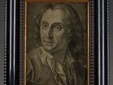 a portrait of a man with long hair in a black frame
