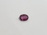 a pink tourmaline gems on a white surface