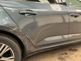a close up of a car that has a denting on the side of it