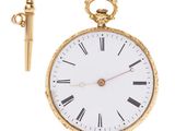 an image of a gold pocket watch with a key on a white background