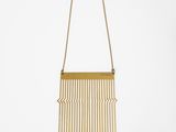 a gold necklace with a fringe hanging from it