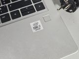 a silver laptop with a sticker on it sitting on a table