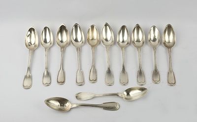 six silver spoons and six spoons are lined up on a white surface