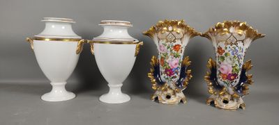 three white vases sitting next to each other on top of a table