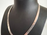 a close up of a necklace on a mannequin neck
