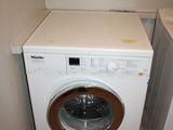 a washer and dryer in the corner of a room