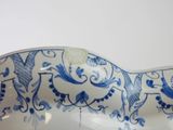 a blue and white bowl with a horse design on it
