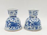 two blue and white vases with flowers on them