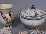 several pieces of pottery sitting on a table with a vase, bowl, and plate