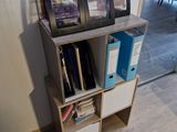 a book shelf with a bunch of books on top of it