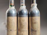 three bottles of wine sitting on top of a table next to each other