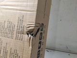 a cardboard box with a bird on it sitting on the floor