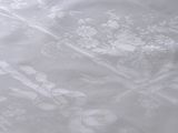 a bed with a white comforter and white sheets on it