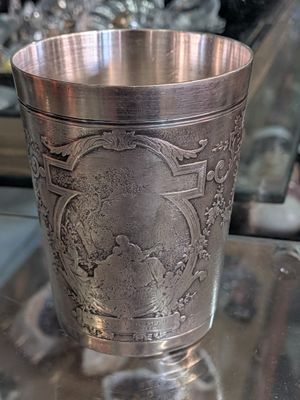 a silver cup sitting on top of a table