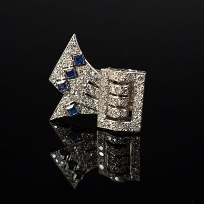a close up of a diamond and sapphire star broochle
