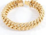 a close up of a gold bracelet on a white background