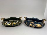 two blue and green dishes with gold leaves on them