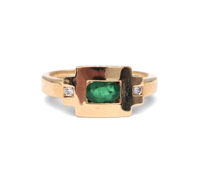 a close up of a gold ring with a green stone and diamonds