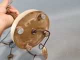 a person that is holding a small clock in their hand