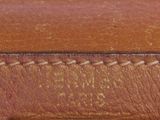 an old brown leather purse with stitching on the inside of it