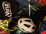 a pile of sports gear and a helmet on a bed