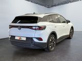 the rear end of a white volkswagen suv parked in a garage