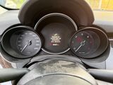 a dashboard with a speedometer, gauges, and a steering wheel
