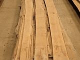 several pieces of wood are stacked on top of each other in a warehouse