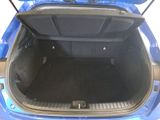 a blue car with its trunk open on the street