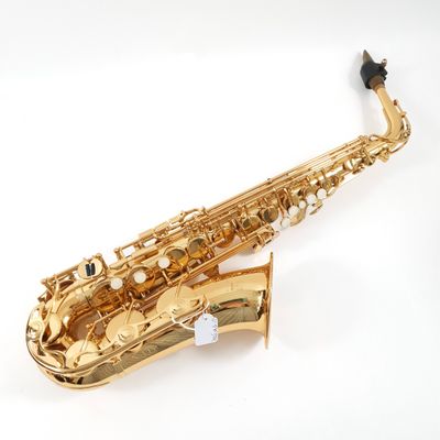 a close up of a gold saxophone on a white background