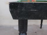 an old pool table with a pool ball on top of it