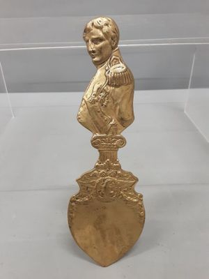 a close up of a gold statue of a man on a pedestal