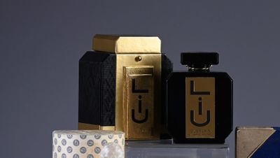 three different types of perfumes sitting on a table