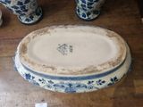 a large blue and white bowl on a wooden table