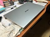 a laptop computer sitting on top of a wooden desk