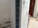 a white refrigerator in the corner of a room with tile flooring