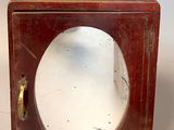 a small wooden box with a glass inside of it