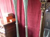 two tall vases sitting next to a mirror in a room