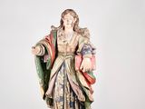 an old statue of a woman holding a book in her hands