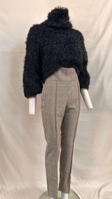 an image of a mannequin wearing a black sweater and plaid pants