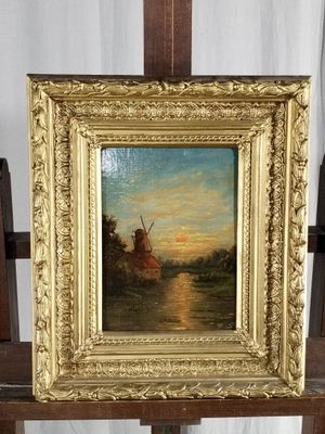 a picture of a painting of a windmill on a easel