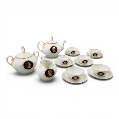 a white tea set with a picture of a woman on it