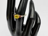 yellow sapphire and diamond ring on a black mannequin hand