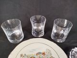 three glasses and a plate with a picture on it